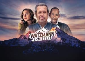 Offizielles Key-Visual zur ARD-Serie "Watzmann ermittelt" mit drei Hauptdarstellern vor einer Bergkulisse im Sonnenuntergang. Im Vordergrund das Logo der Serie, ein stilisierter Watzmann-Gipfel mit Schriftzug.