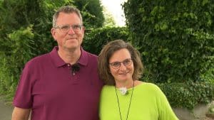 "Duell der Gartenprofis - Mein grünes Paradies": Michaela und Martin Heybeck stehen Arm in Arm im Garten und schauen lächelnd nach vorne.