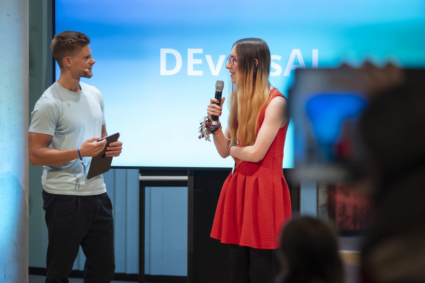 Bundeswettbewerb Künstliche Intelligenz: Junge KI-Talente überraschen mit mutigen Ideen – Hauptpreis geht nach Stralsund 2 Bundeswettbewerb Künstliche Intelligenz: Junge KI-Talente überraschen mit mutigen Ideen – Hauptpreis geht nach Stralsund BWKI2025 Preisverleihung Moderator Philip Haeusser mit Preistraegerin Leo Blume